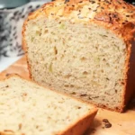 Freshly baked multigrain loaf made using Dave's Killer Bread Maker, with a soft interior and a golden crust.