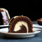 Slice of chocolate Bundt cake with cream cheese filling and chocolate glaze on a white plate