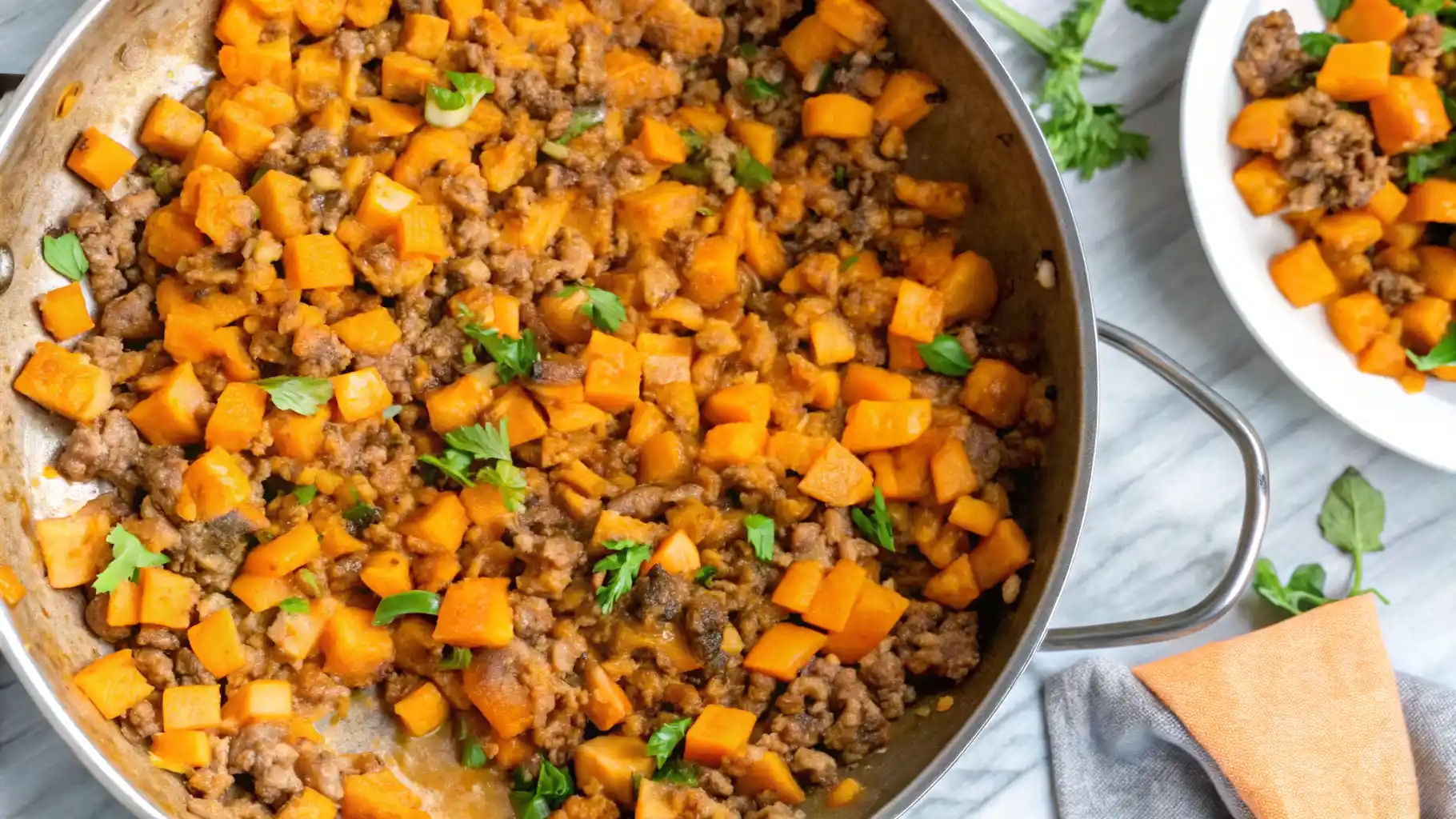 Ground beef and sweet potato skillet with melted cheese and herbs