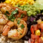 Grilled shrimp burrito bowl with rice, black beans, corn, guacamole, salsa, and pico de gallo.