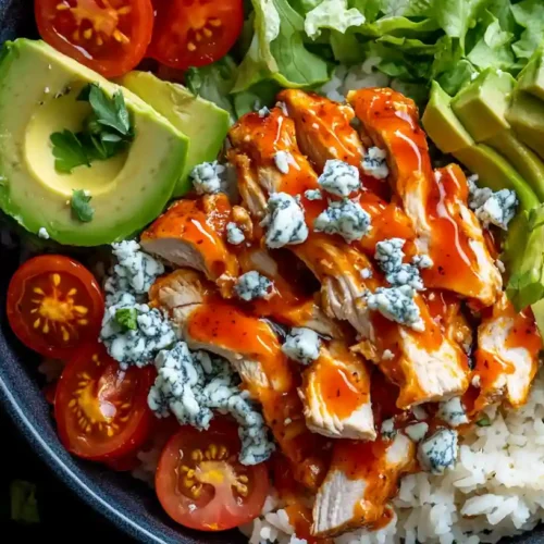 Buffalo chicken bowl with avocado, cherry tomatoes, blue cheese, and white rice