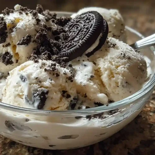 Bowl of homemade cookies and cream ice cream topped with Oreo cookie crumbles