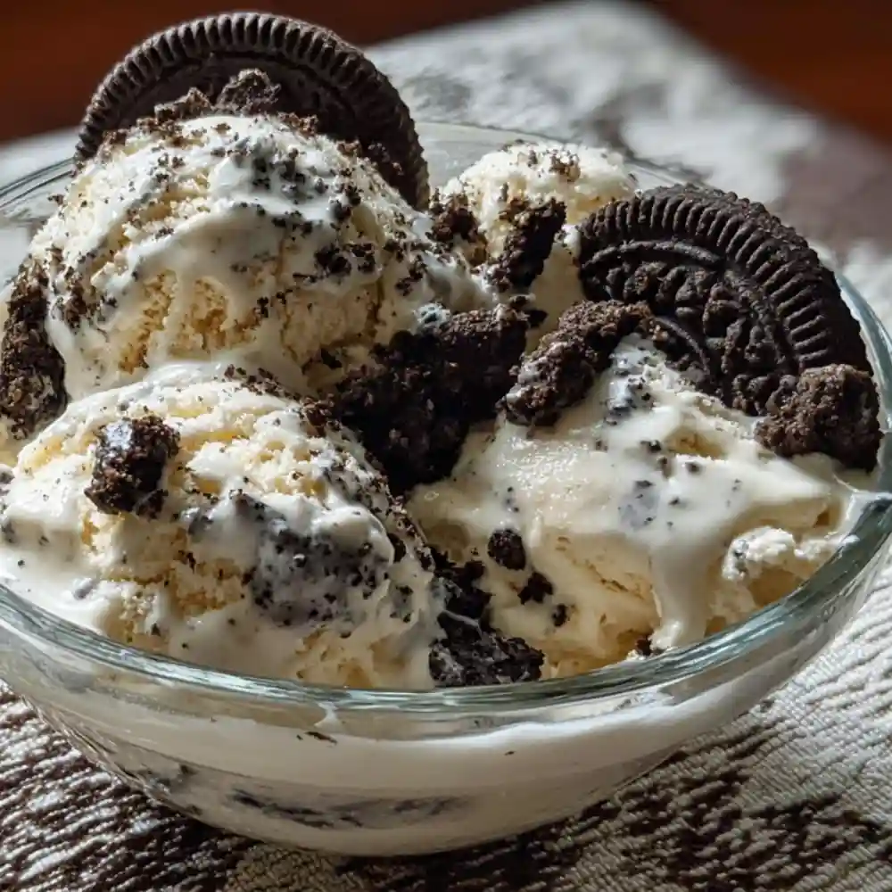 Bowl of homemade cookies and cream ice cream topped with Oreo crumbles and whole cookies
