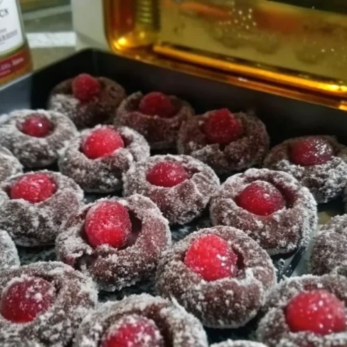 Delicious cherry rum balls coated in chocolate and adorned with cherries