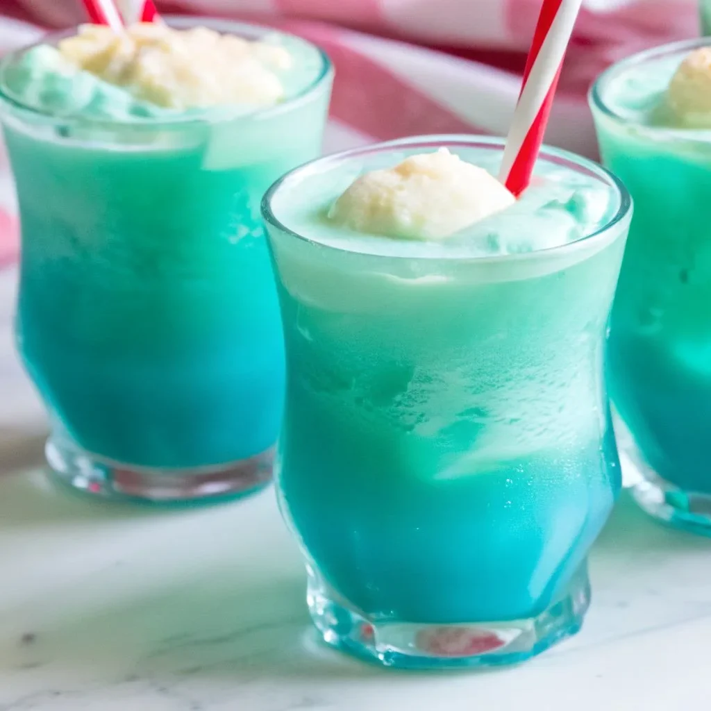 A colorful Frozen Snowball Punch served in a festive glass, garnished with fruit.